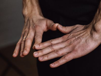 Close-up on hands in a meditative mudra position.