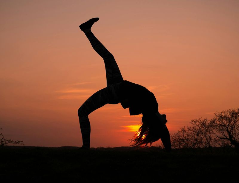 Main photo of a person in a dynamic yoga pose.